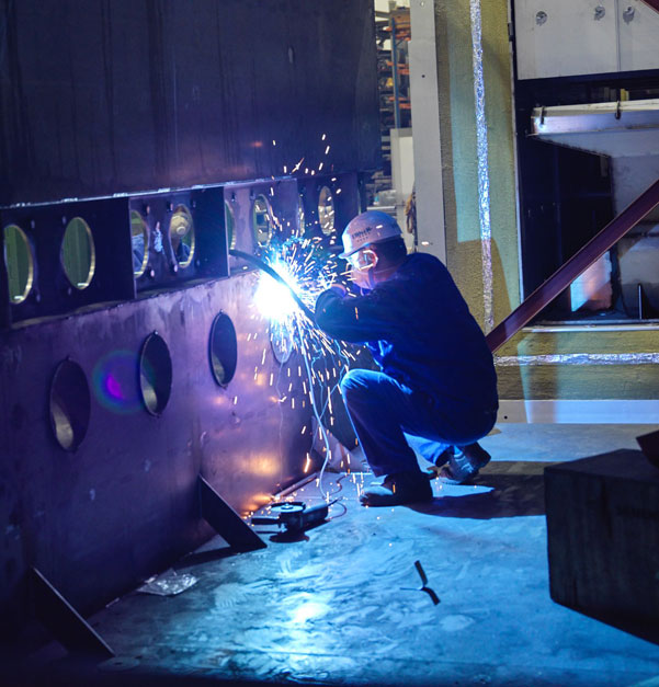 Metal worker welding at EQMS